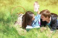 Happy young couple reading book in green park Royalty Free Stock Photo