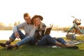 Happy young couple reading book while having picnic Royalty Free Stock Photo