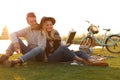 Happy young couple reading book while having picnic Royalty Free Stock Photo