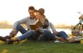 Happy young couple reading book while having picnic Royalty Free Stock Photo