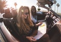 Happy young couple reading city map inside convertible sport car - Travel people having fun on hoildays doing road trip - Vacation Royalty Free Stock Photo
