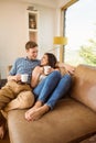 Happy young couple relaxing on the couch Royalty Free Stock Photo