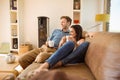 Happy young couple relaxing on the couch Royalty Free Stock Photo