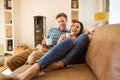 Happy young couple relaxing on the couch Royalty Free Stock Photo