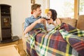 Happy young couple relaxing on the couch with red wine Royalty Free Stock Photo