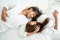 Happy young couple relaxing in the home bedroom. Royalty Free Stock Photo