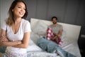 Happy couple relaxing in home bedroom after waking up in the morning. Royalty Free Stock Photo
