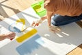 Top view young couple relaxing, painting on sheet of paper in new house on the floor Royalty Free Stock Photo