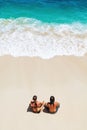 Happy young couple relaxing on white sand sea beach Royalty Free Stock Photo