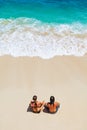 Happy young couple relaxing on white sand sea beach Royalty Free Stock Photo