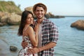 Happy young couple resting on sandy sea beach Royalty Free Stock Photo