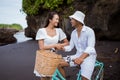 happy young couple riding bicycles on beach Royalty Free Stock Photo