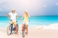 Happy family riding bicycles on the beach Royalty Free Stock Photo