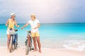 Happy family riding bicycles on the beach Royalty Free Stock Photo
