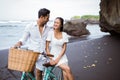 happy young couple riding bicycles on beach Royalty Free Stock Photo