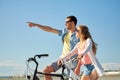 Happy young couple riding bicycles at seaside Royalty Free Stock Photo