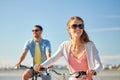 Happy young couple riding bicycles at seaside Royalty Free Stock Photo