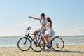 Happy young couple riding bicycles at seaside Royalty Free Stock Photo