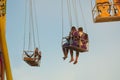 Happy young couple riding a carousel in an amusement park. Royalty Free Stock Photo
