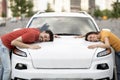 Happy young couple hugging their brand new white car Royalty Free Stock Photo