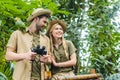 happy young couple in safari suits with parrot