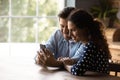 Happy young couple sharing mobile phone, watching content Royalty Free Stock Photo