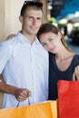 happy young couple with shopping bags hugging each other