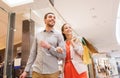 Happy young couple with shopping bags in mall Royalty Free Stock Photo