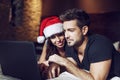 Happy young couple shopping online for Chrsitmas on laptop Royalty Free Stock Photo