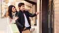 Happy couple shopping together, man pointing at shop window Royalty Free Stock Photo