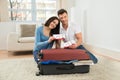 Happy young couple showing boarding pass