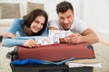 Happy young couple showing boarding pass