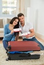 Happy young couple showing boarding pass