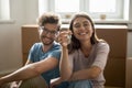 Happy young couple showing keys from hew home together Royalty Free Stock Photo