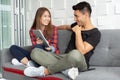 Happy young couple are sitting on couch and using digital tablet Royalty Free Stock Photo