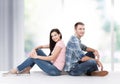 Happy young couple sitting on floor looking up while dreaming their new home and furnishing. Mock up Royalty Free Stock Photo