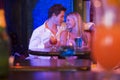 Happy young couple sitting in a nightclub, smiling Royalty Free Stock Photo