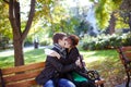 Happy young couple sitting on a park bench Royalty Free Stock Photo