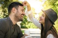 Happy young couple sitting in the park drinking coffee Royalty Free Stock Photo