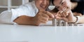 Happy Young Couple sitting with stacks of golden coins over table at home Royalty Free Stock Photo