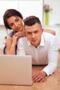 Happy young couple sitting together on the floor Royalty Free Stock Photo