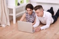 Happy young couple sitting together on the floor Royalty Free Stock Photo