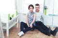 Happy young couple sitting together on the floor Royalty Free Stock Photo