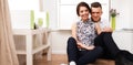 Happy young couple sitting together on the floor Royalty Free Stock Photo