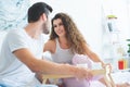happy young couple smiling each other while having breakfast together Royalty Free Stock Photo