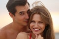 Happy young couple spending time  on sea beach at sunset Royalty Free Stock Photo