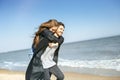 Happy young couple spending time on the sea shore in spring Royalty Free Stock Photo