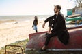 Happy young couple spending time on the sea shore in spring Royalty Free Stock Photo