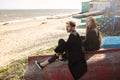 Happy young couple spending time on the sea shore in spring Royalty Free Stock Photo