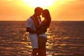 Happy young couple spending time  on sea beach at sunset Royalty Free Stock Photo